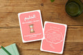 Sakina Cards: Al-Haleem (The Patient) Name of Allah card with hourglass and a parent affirmation card on a wooden table